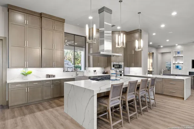 a kitchen with center island table and chairs in it
