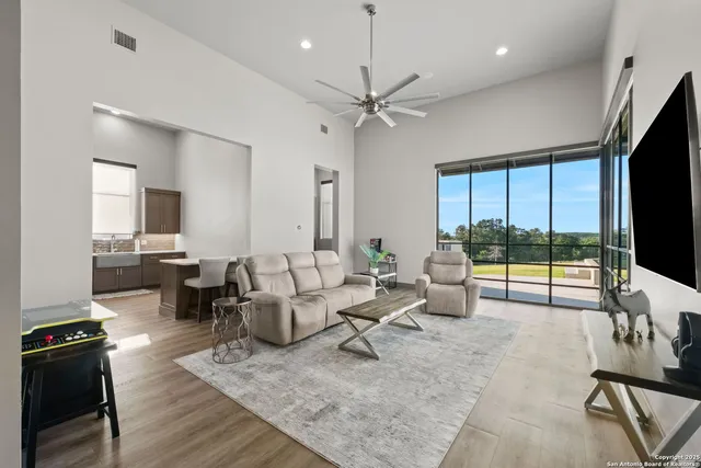 a living room with fireplace furniture and a flat screen tv