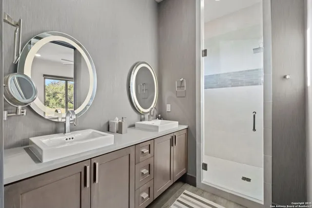 a bathroom with 2 sink and a mirror