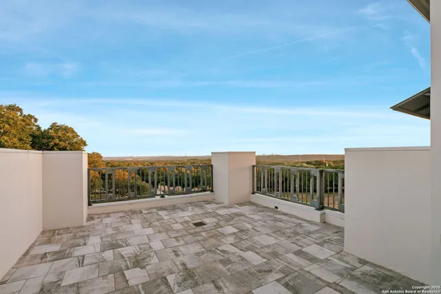a view of balcony with wooden fence