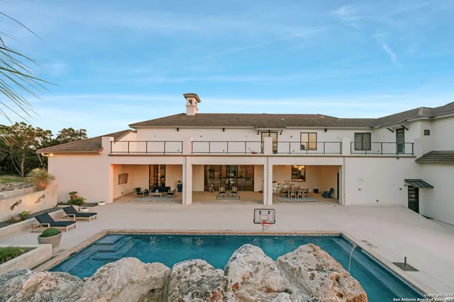 a view of a house with swimming pool and furniture