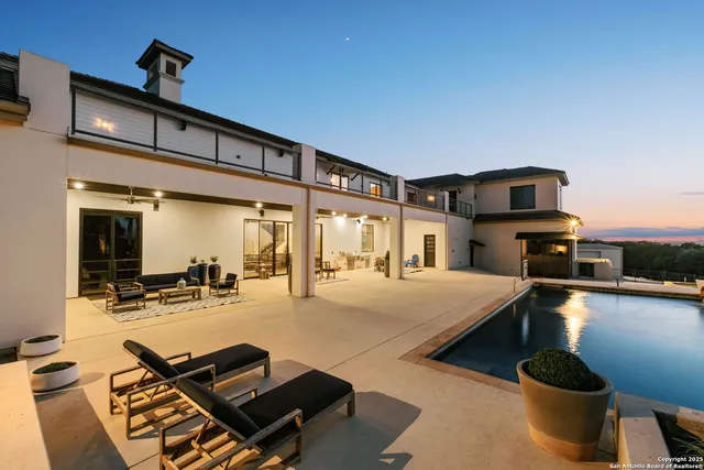 a living room with furniture a flat screen tv and a table