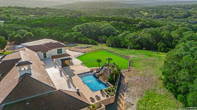 an aerial view of a house with a yard