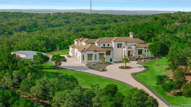 an aerial view of a house with swimming pool garden and patio