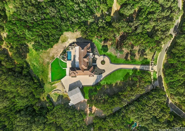 an aerial view of a house with outdoor space and street view