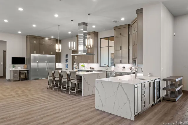 a large kitchen with lots of counter space a sink and appliances