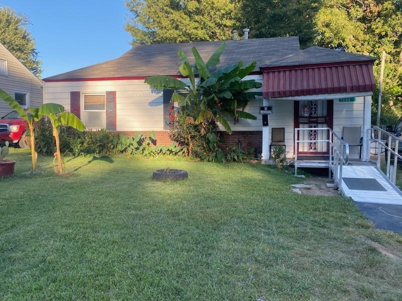 1582 Railton Road Memphis, TN 38111 - Photo 1 of 1 a view of a house with a yard potted plants and a bench