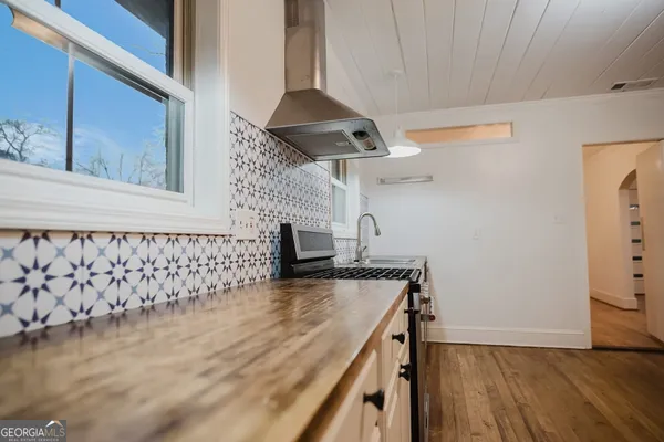 a view of a refrigerator in kitchen and wooden floor