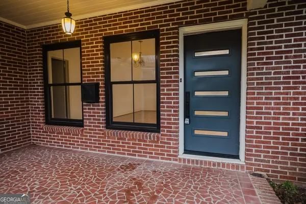 a brick house with a door and a yard