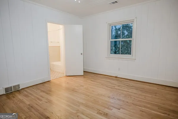 a view of a room with wooden floor and a sink