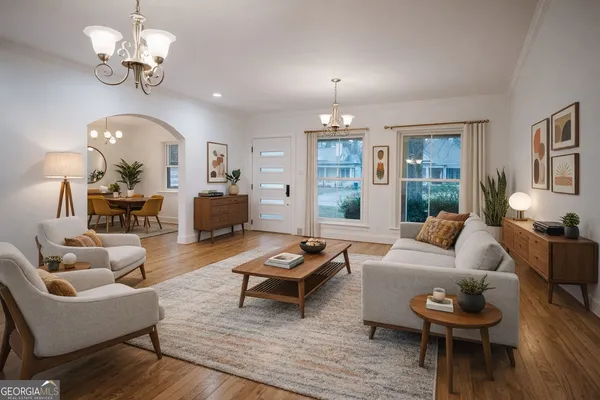 a bedroom with a large bed and a chandelier