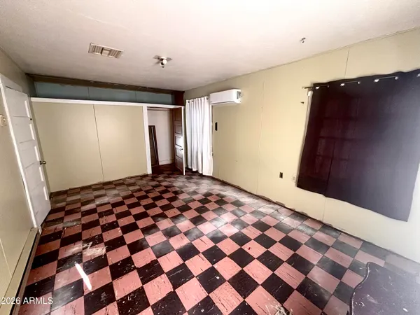 a bedroom with a black and white checkered floor