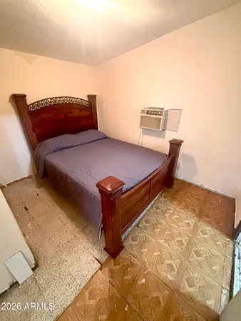 a bedroom with a bed and lamp