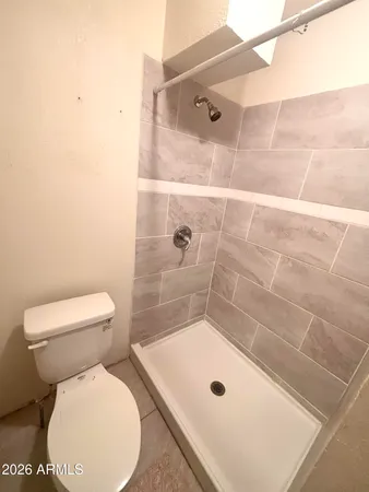 a bathroom with a toilet and shower