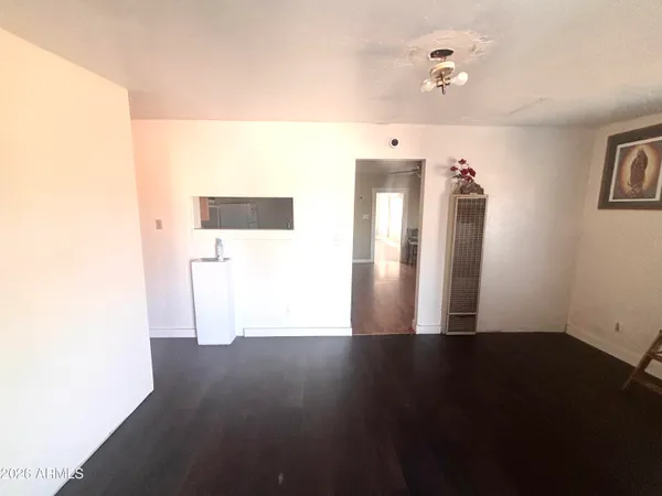 a view of a room with wooden floor