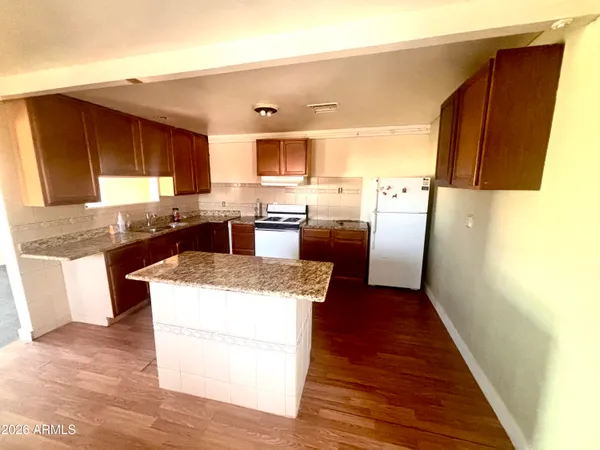 a kitchen with granite countertop counter top space a sink stainless steel appliances and cabinets
