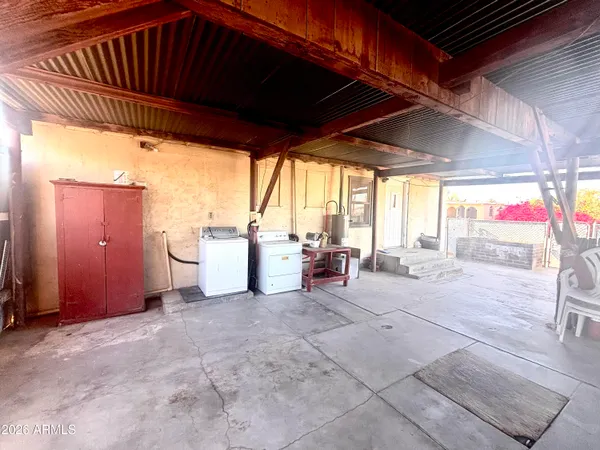 a view of a backyard with table and chairs
