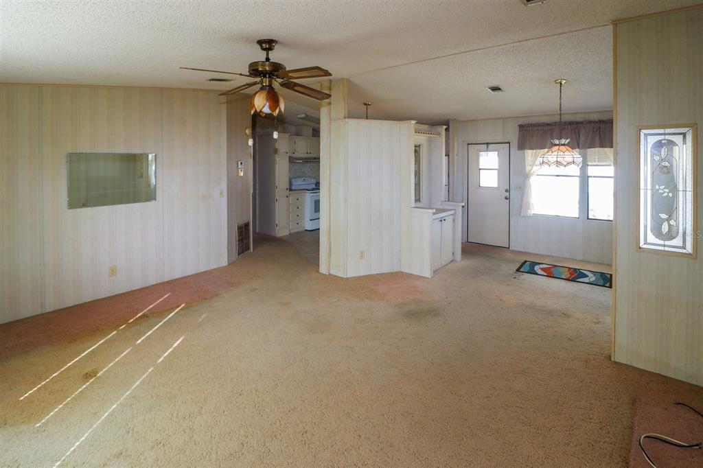 29200 South Jones Loop Road, Unit 176 Punta Gorda, FL 33950 - Photo 12 of 31 a view of a livingroom with a chandelier fan and windows