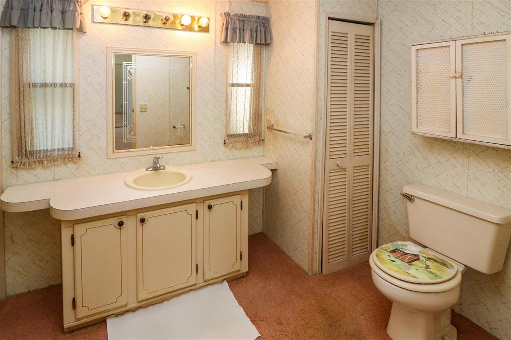 29200 South Jones Loop Road, Unit 176 Punta Gorda, FL 33950 - Photo 25 of 31 a bathroom with a sink a toilet and shower