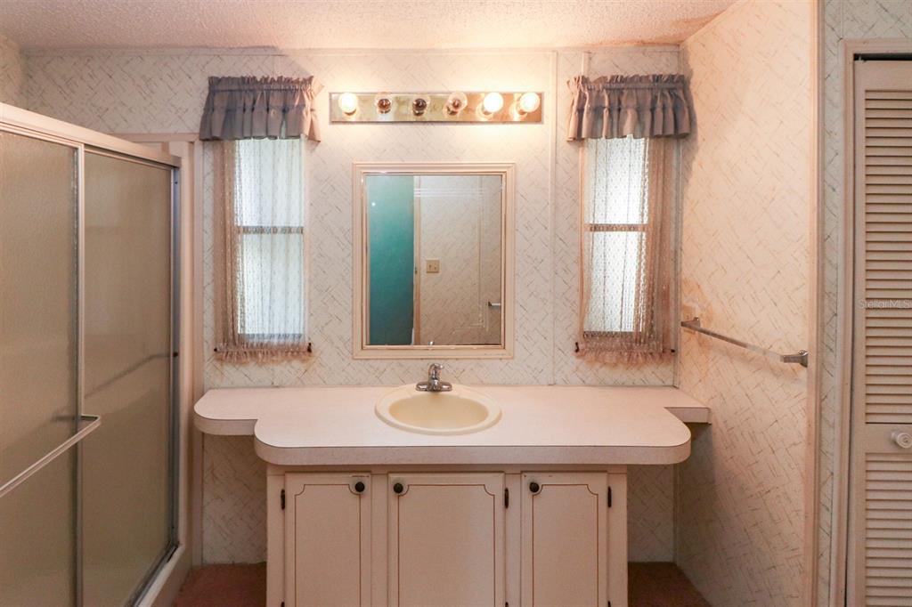 29200 South Jones Loop Road, Unit 176 Punta Gorda, FL 33950 - Photo 26 of 31 a bathroom with a sink and a mirror