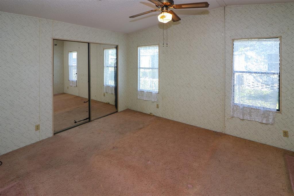 29200 South Jones Loop Road, Unit 176 Punta Gorda, FL 33950 - Photo 27 of 31 an empty room with fan and windows