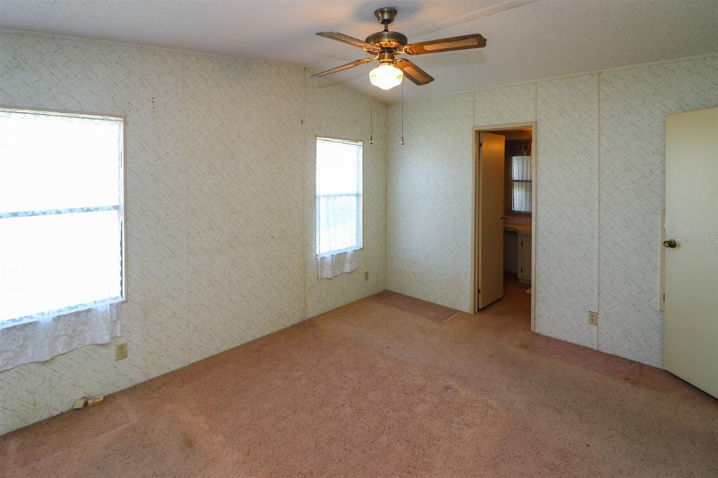 29200 South Jones Loop Road, Unit 176 Punta Gorda, FL 33950 - Photo 31 of 31 an empty room with windows and fan