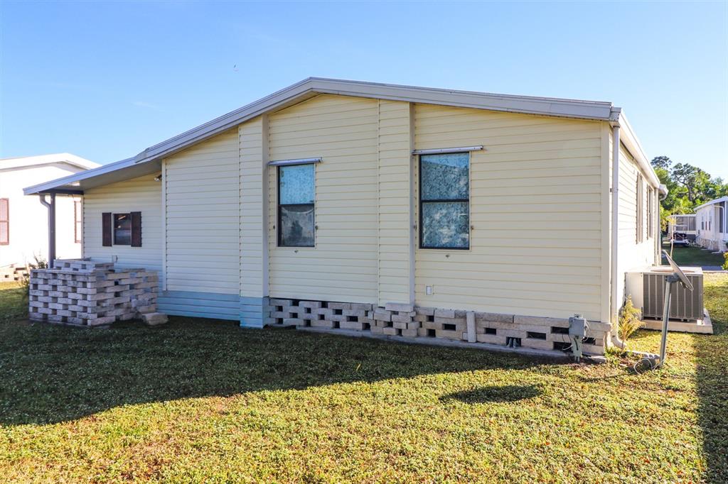 29200 South Jones Loop Road, Unit 176 Punta Gorda, FL 33950 - Photo 7 of 31 a front view of a house with garden