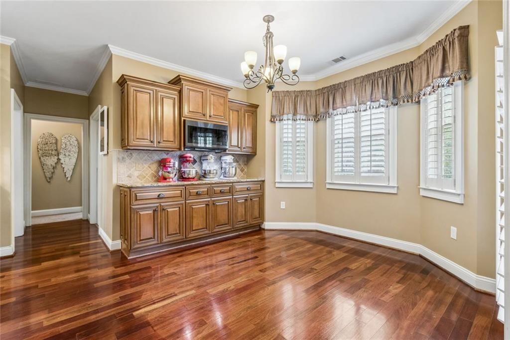20 Stampede Pass Rydal, GA 30171 - Photo 23 of 77 a kitchen with stainless steel appliances granite countertop a stove a sink dishwasher a microwave oven and a dining table with wooden floor