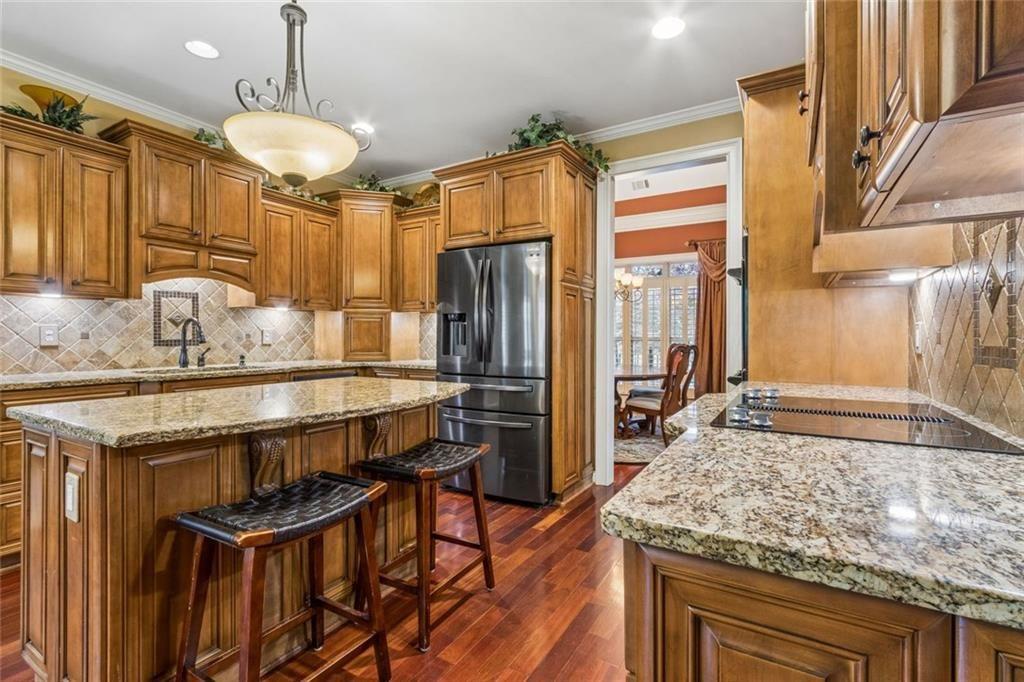 20 Stampede Pass Rydal, GA 30171 - Photo 27 of 77 a kitchen with stainless steel appliances granite countertop a stove refrigerator and cabinets