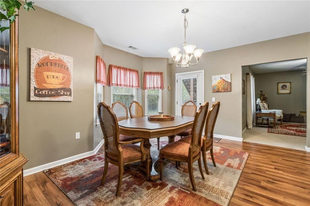 20 Stampede Pass Rydal, GA 30171 - Photo 51 of 77 a view of a dining room with furniture a chandelier and wooden floor