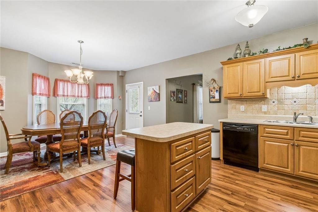 20 Stampede Pass Rydal, GA 30171 - Photo 56 of 77 a open kitchen with stainless steel appliances granite countertop a stove top oven a sink dishwasher and white cabinets with wooden floor
