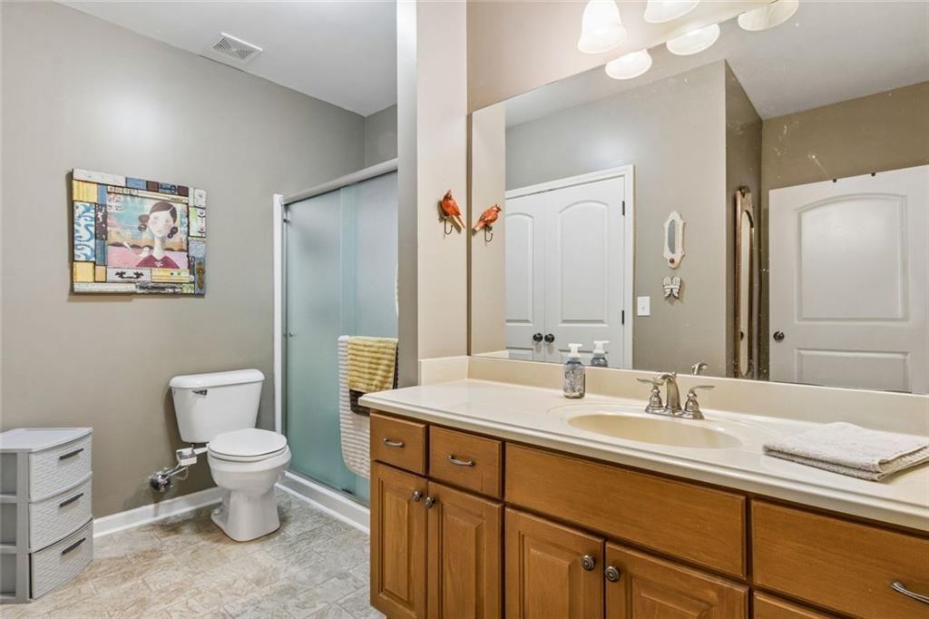 20 Stampede Pass Rydal, GA 30171 - Photo 60 of 77 a bathroom with a toilet sink and mirror