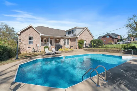 a view of a house with garden and yard