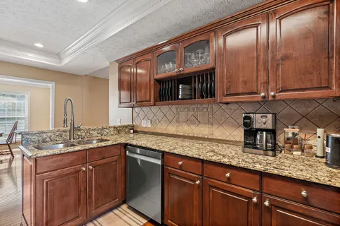 a kitchen with a refrigerator a stove a sink and a window