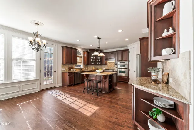 a bathroom with a sink a toilet a large mirror and shower