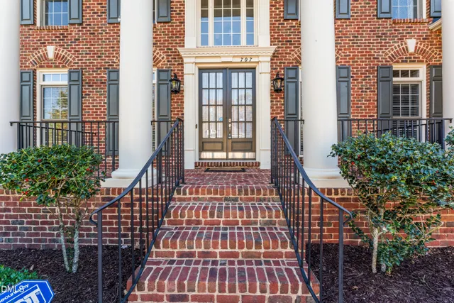 a view of entryway livingroom and hall with wooden floor