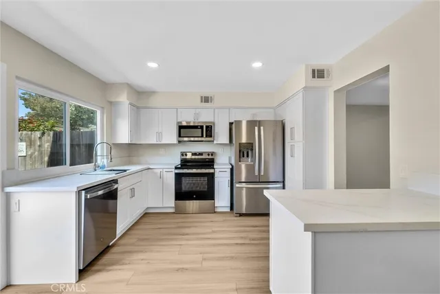 a view of living room with granite countertop cabinets and wooden floor