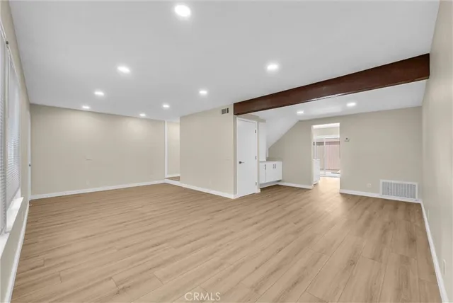 wooden floor in an empty room with a window