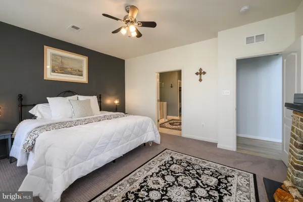 a bedroom with bed and wooden floor