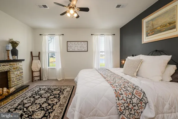 a bedroom with a bed and a fireplace