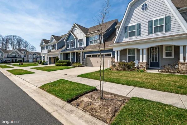 a front view of a house with a yard table and chairs