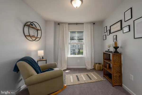 a living room with furniture a window and a chandelier