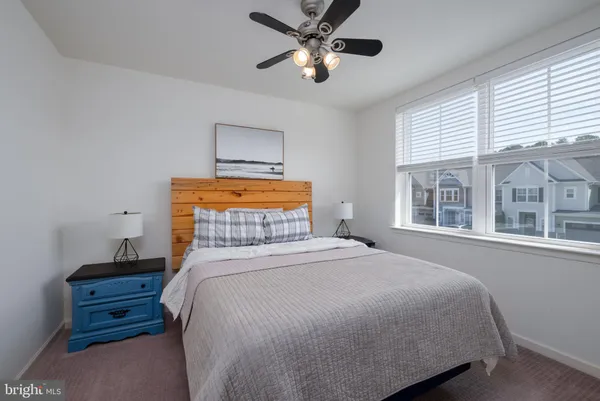 a bedroom with a large bed and a large window