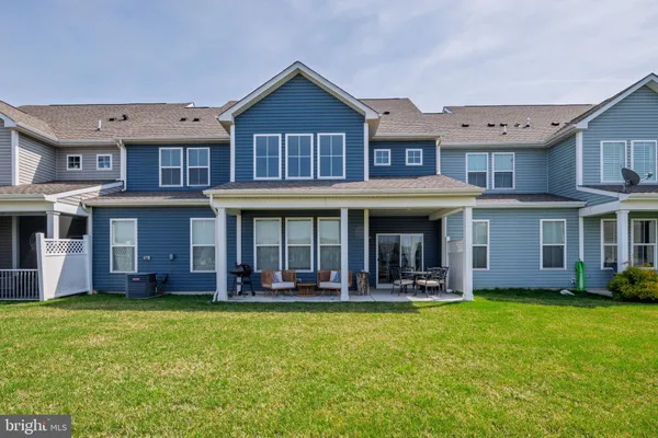 a front view of a building and yard with swimming pool