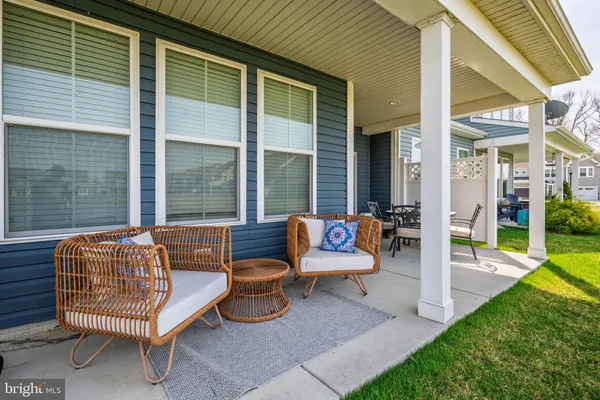a backyard of a house with barbeque oven table and chairs