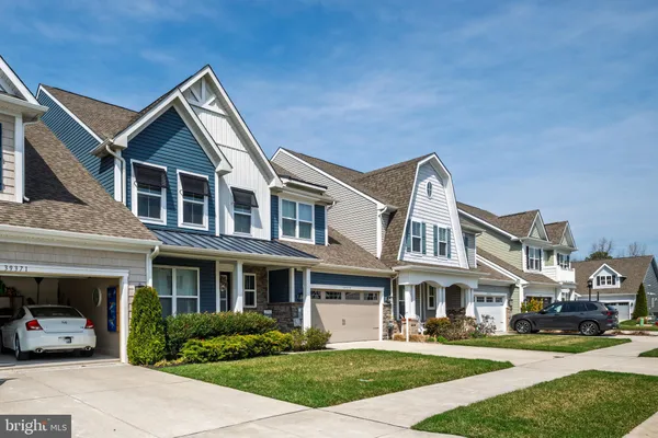 a front view of residential houses with yard