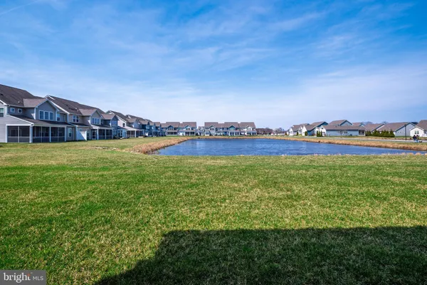 a view of a lake with houses in the back
