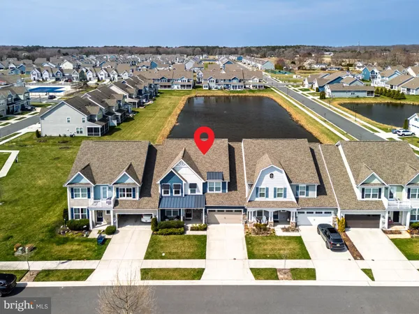 a view of multiple houses with a swimming pool