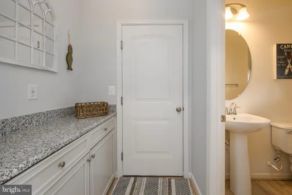 a view of bathroom with a sink and mirror
