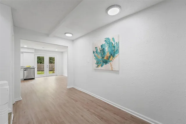 wooden floor in an empty room with a window